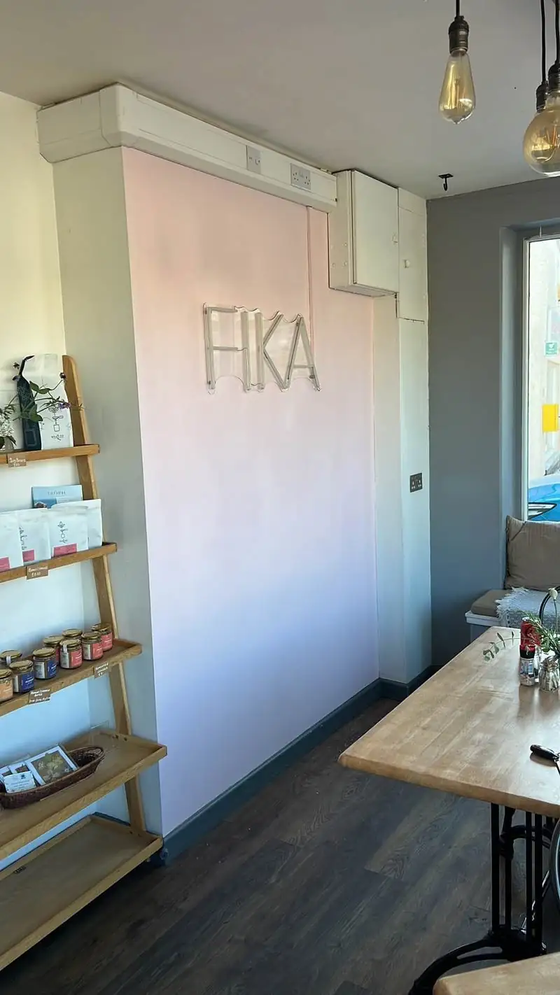 The same wall repainted in a soft pink with the sign back up