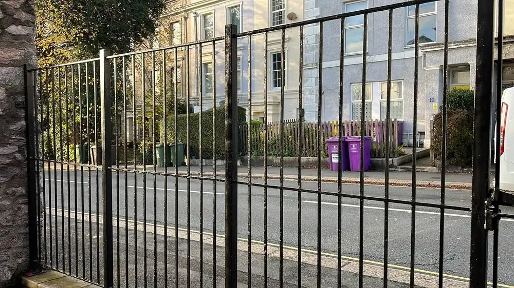 The same metal railings after sanding, preparation and a fresh coat of black paint