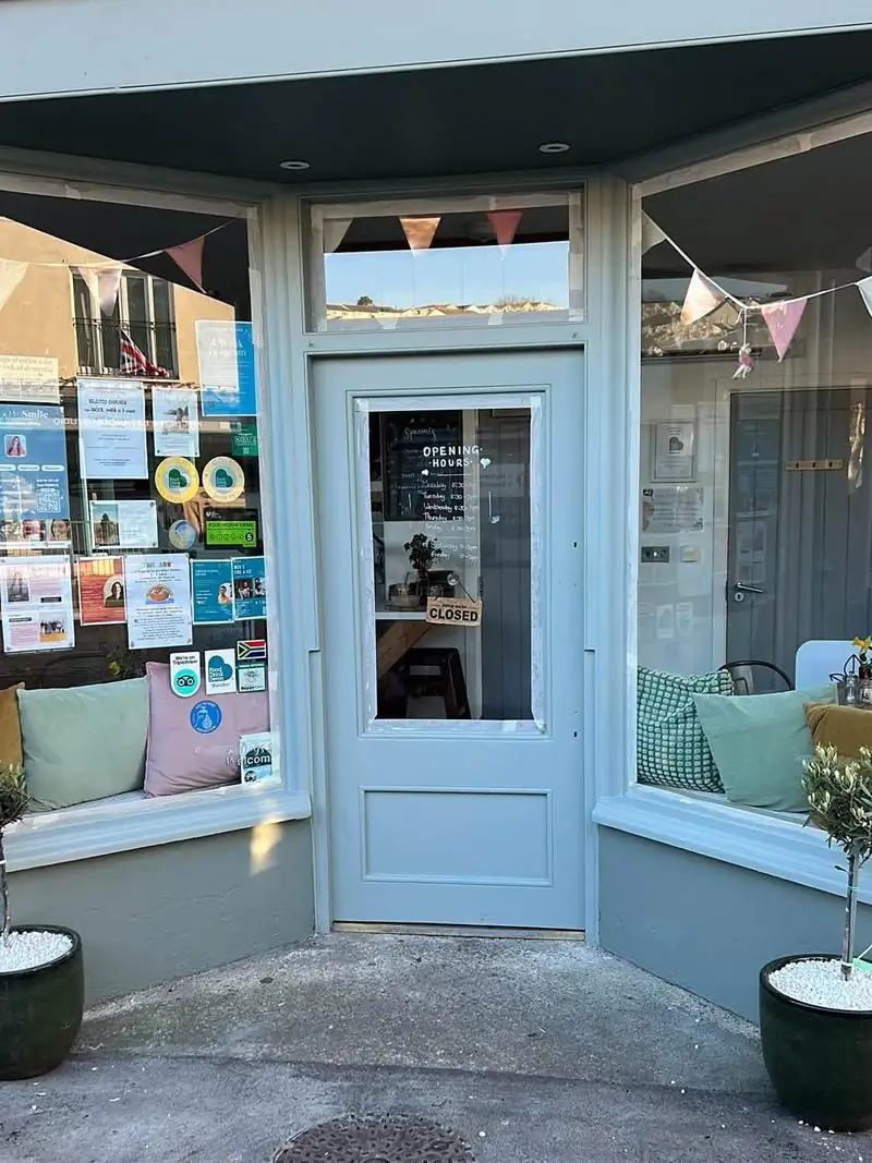 The same shop entrance after the woodwork was prepared and repainted